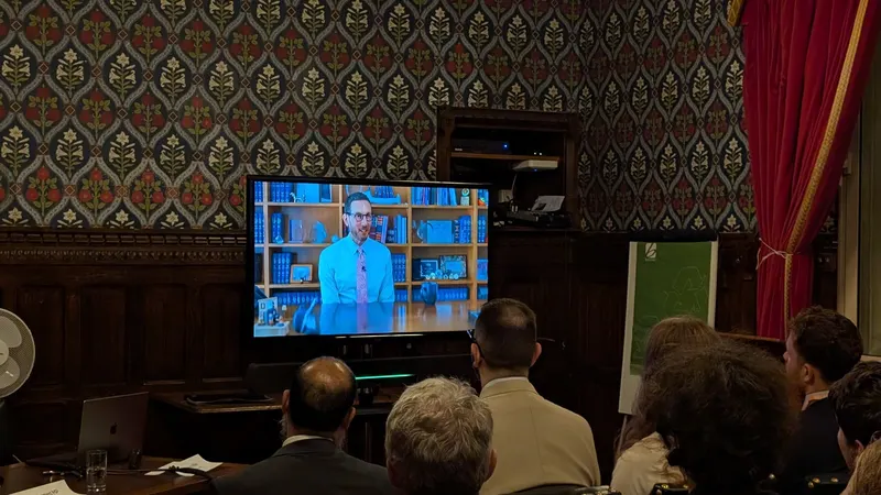 Scott Wiener on screen at a PauseAI event